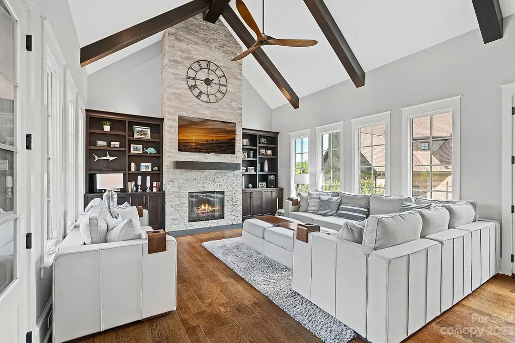 This stunning home in Providence Downs South offers luxury resort living with spa-like amenities, perfect for entertaining and relaxing. It has 5 bedrooms, 4 full baths, and 3 half baths, plus a 4-car garage with epoxy floor. The kitchen has a huge island with Wolf & Subzero appliances, and the backyard has a heated pool, hot tub, and pool house with sauna. 