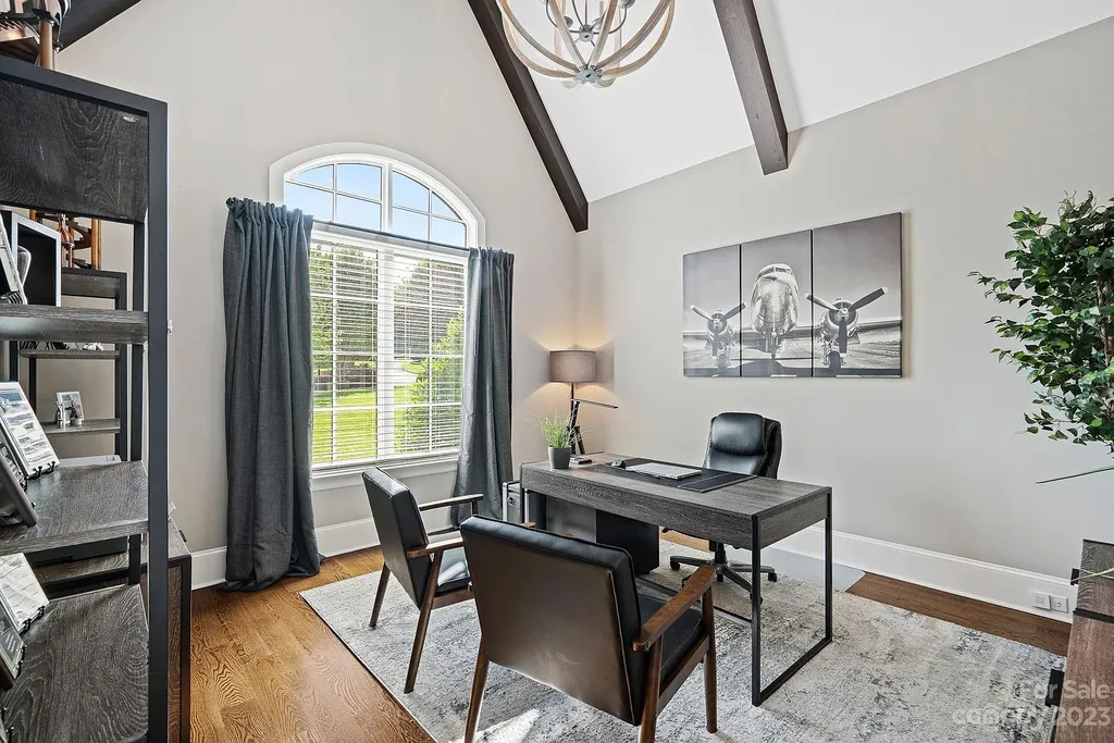 This stunning home in Providence Downs South offers luxury resort living with spa-like amenities, perfect for entertaining and relaxing. It has 5 bedrooms, 4 full baths, and 3 half baths, plus a 4-car garage with epoxy floor. The kitchen has a huge island with Wolf & Subzero appliances, and the backyard has a heated pool, hot tub, and pool house with sauna. 