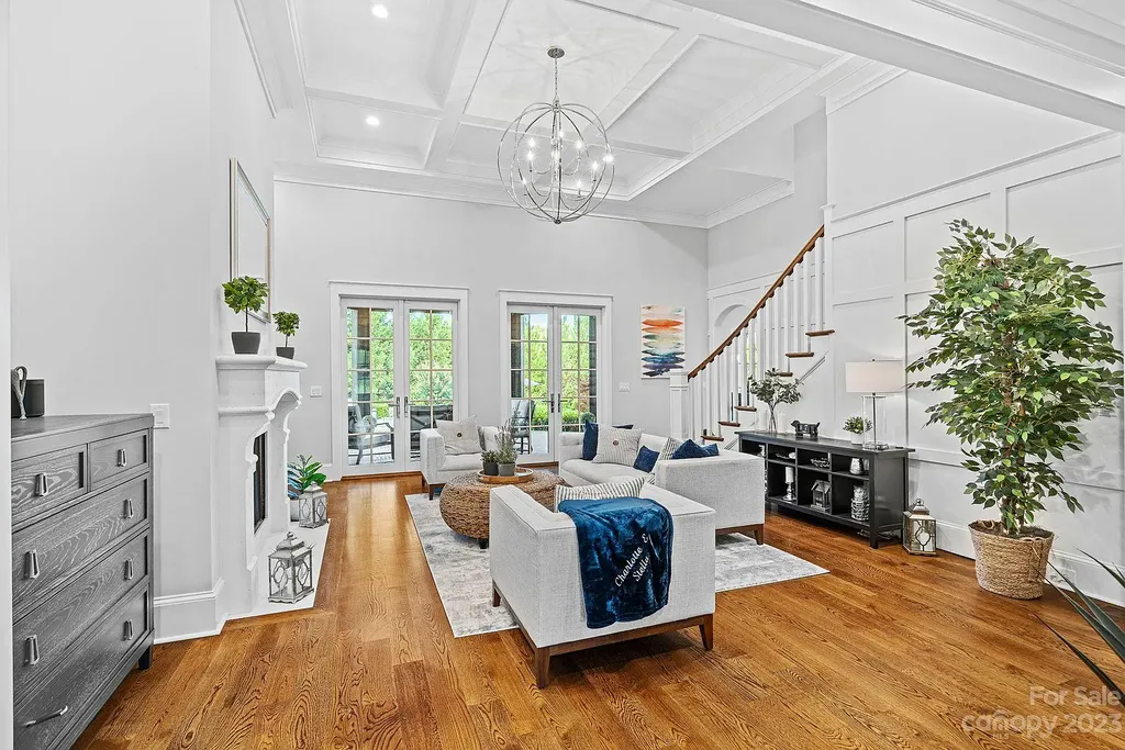 This stunning home in Providence Downs South offers luxury resort living with spa-like amenities, perfect for entertaining and relaxing. It has 5 bedrooms, 4 full baths, and 3 half baths, plus a 4-car garage with epoxy floor. The kitchen has a huge island with Wolf & Subzero appliances, and the backyard has a heated pool, hot tub, and pool house with sauna. 