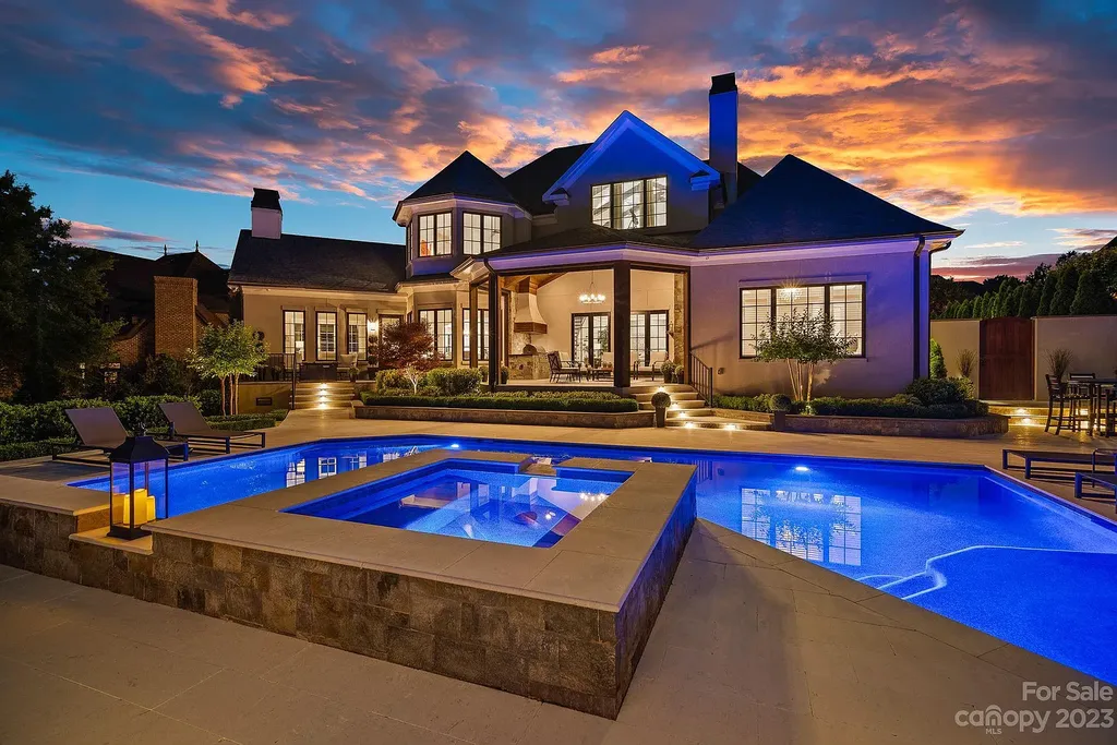 This stunning home in Providence Downs South offers luxury resort living with spa-like amenities, perfect for entertaining and relaxing. It has 5 bedrooms, 4 full baths, and 3 half baths, plus a 4-car garage with epoxy floor. The kitchen has a huge island with Wolf & Subzero appliances, and the backyard has a heated pool, hot tub, and pool house with sauna. 