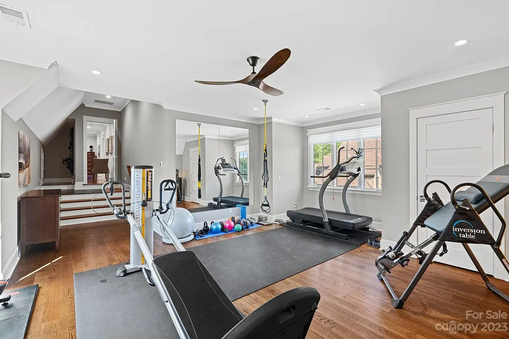 This stunning home in Providence Downs South offers luxury resort living with spa-like amenities, perfect for entertaining and relaxing. It has 5 bedrooms, 4 full baths, and 3 half baths, plus a 4-car garage with epoxy floor. The kitchen has a huge island with Wolf & Subzero appliances, and the backyard has a heated pool, hot tub, and pool house with sauna. 