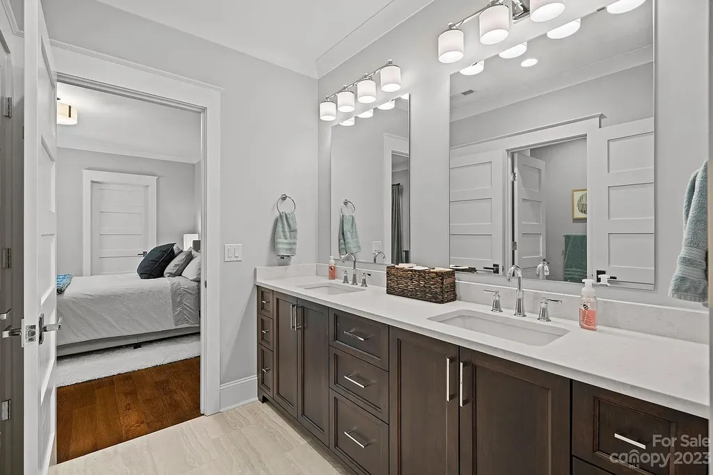 This stunning home in Providence Downs South offers luxury resort living with spa-like amenities, perfect for entertaining and relaxing. It has 5 bedrooms, 4 full baths, and 3 half baths, plus a 4-car garage with epoxy floor. The kitchen has a huge island with Wolf & Subzero appliances, and the backyard has a heated pool, hot tub, and pool house with sauna. 