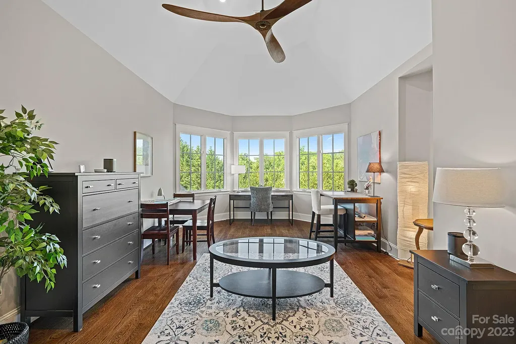 This stunning home in Providence Downs South offers luxury resort living with spa-like amenities, perfect for entertaining and relaxing. It has 5 bedrooms, 4 full baths, and 3 half baths, plus a 4-car garage with epoxy floor. The kitchen has a huge island with Wolf & Subzero appliances, and the backyard has a heated pool, hot tub, and pool house with sauna. 
