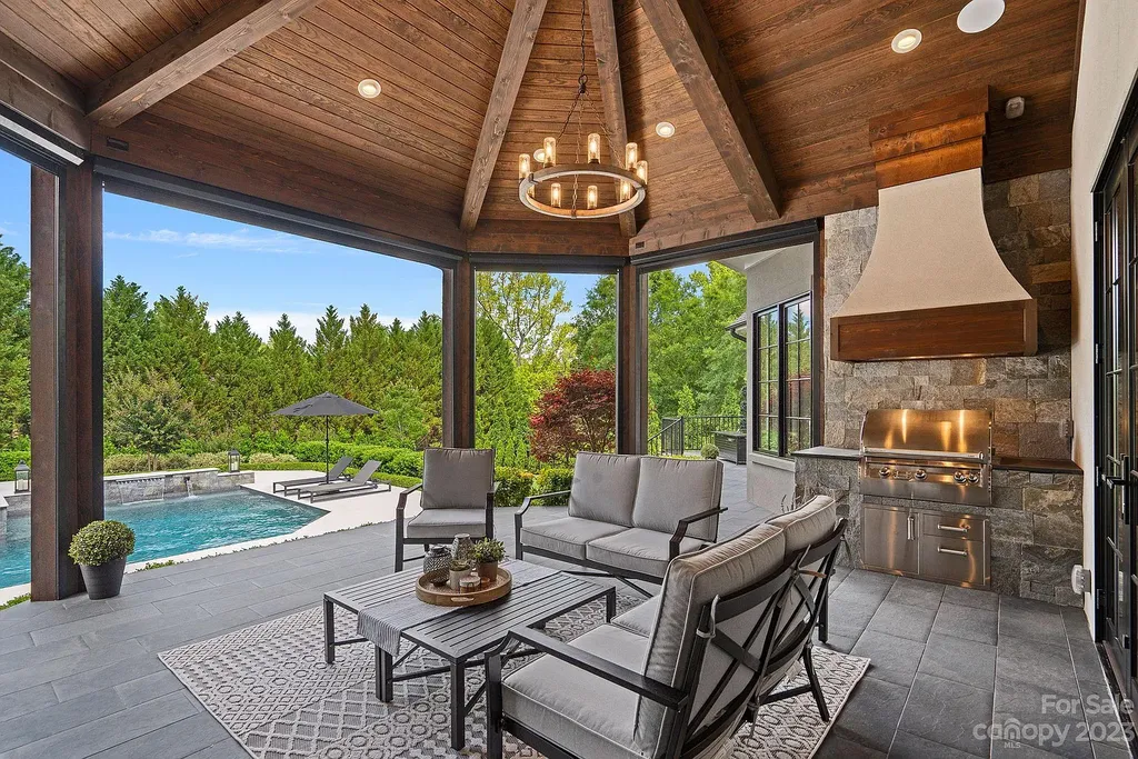 This stunning home in Providence Downs South offers luxury resort living with spa-like amenities, perfect for entertaining and relaxing. It has 5 bedrooms, 4 full baths, and 3 half baths, plus a 4-car garage with epoxy floor. The kitchen has a huge island with Wolf & Subzero appliances, and the backyard has a heated pool, hot tub, and pool house with sauna. 