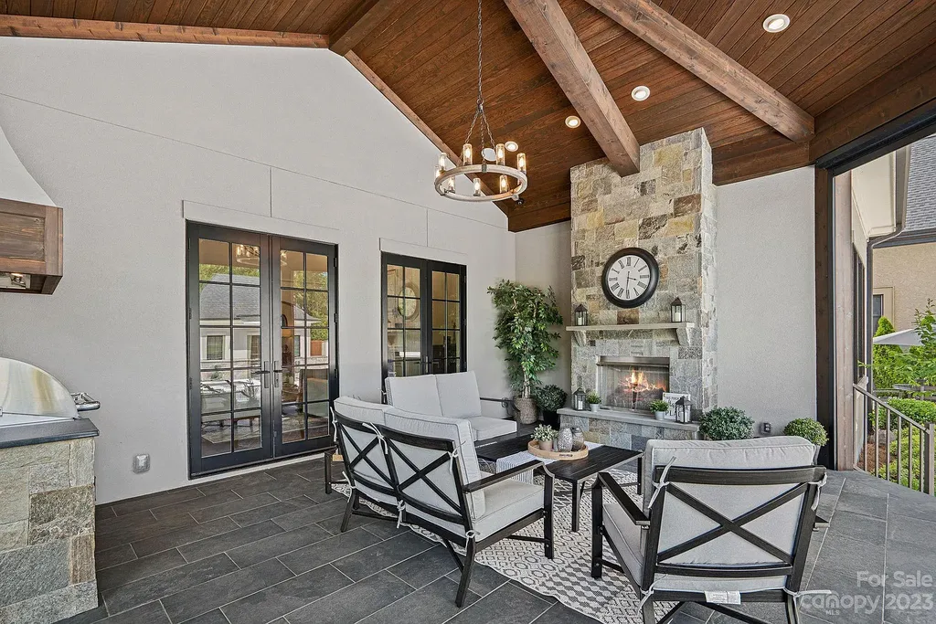 This stunning home in Providence Downs South offers luxury resort living with spa-like amenities, perfect for entertaining and relaxing. It has 5 bedrooms, 4 full baths, and 3 half baths, plus a 4-car garage with epoxy floor. The kitchen has a huge island with Wolf & Subzero appliances, and the backyard has a heated pool, hot tub, and pool house with sauna. 