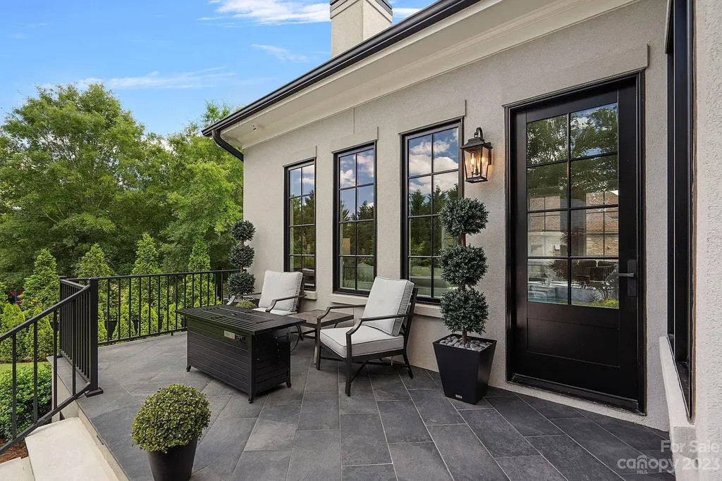 This stunning home in Providence Downs South offers luxury resort living with spa-like amenities, perfect for entertaining and relaxing. It has 5 bedrooms, 4 full baths, and 3 half baths, plus a 4-car garage with epoxy floor. The kitchen has a huge island with Wolf & Subzero appliances, and the backyard has a heated pool, hot tub, and pool house with sauna. 