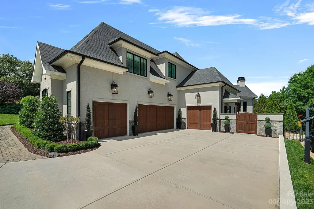 This stunning home in Providence Downs South offers luxury resort living with spa-like amenities, perfect for entertaining and relaxing. It has 5 bedrooms, 4 full baths, and 3 half baths, plus a 4-car garage with epoxy floor. The kitchen has a huge island with Wolf & Subzero appliances, and the backyard has a heated pool, hot tub, and pool house with sauna. 