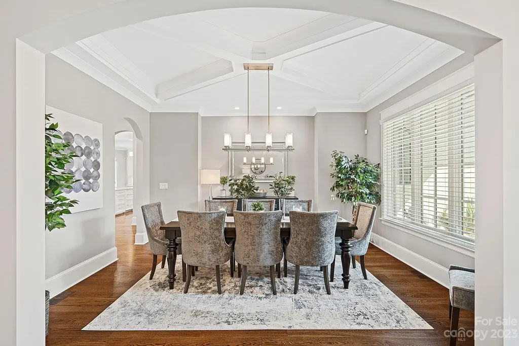 This stunning home in Providence Downs South offers luxury resort living with spa-like amenities, perfect for entertaining and relaxing. It has 5 bedrooms, 4 full baths, and 3 half baths, plus a 4-car garage with epoxy floor. The kitchen has a huge island with Wolf & Subzero appliances, and the backyard has a heated pool, hot tub, and pool house with sauna. 