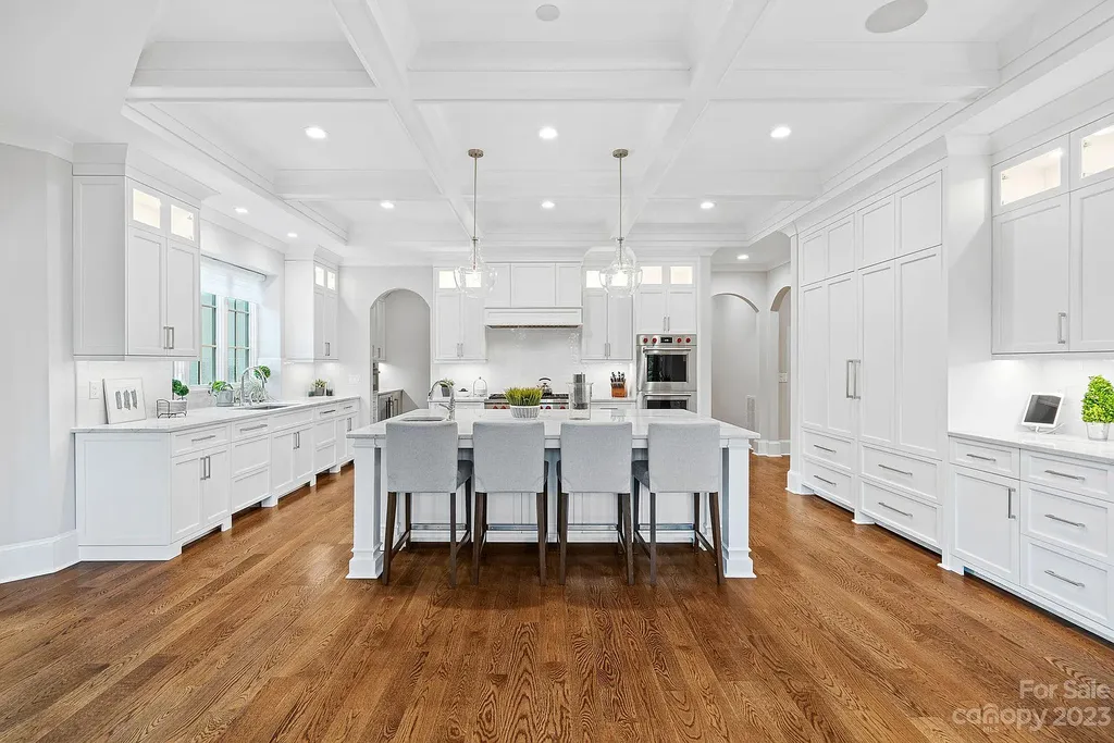 This stunning home in Providence Downs South offers luxury resort living with spa-like amenities, perfect for entertaining and relaxing. It has 5 bedrooms, 4 full baths, and 3 half baths, plus a 4-car garage with epoxy floor. The kitchen has a huge island with Wolf & Subzero appliances, and the backyard has a heated pool, hot tub, and pool house with sauna. 