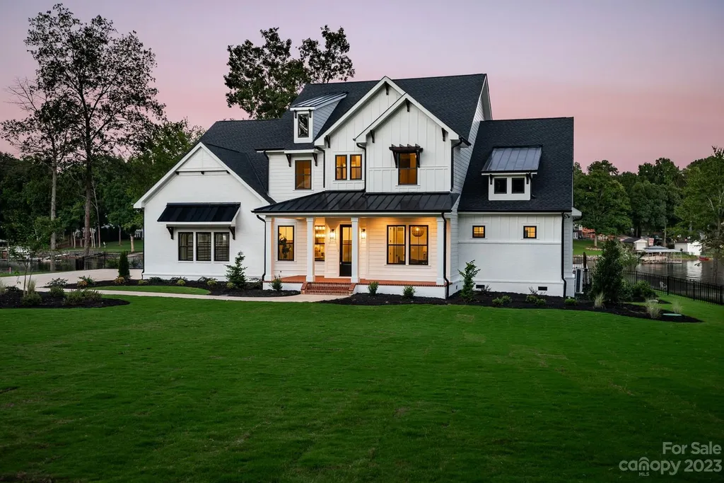155 Riverwood Road Home in Mooresville, North Carolina. Experience the epitome of luxury in this new construction home on Lake Norman. Boasting 4 bedrooms, 4.5 bathrooms, a pool, dock, and breathtaking lake views, this home offers a lifestyle of comfort and elegance. 
