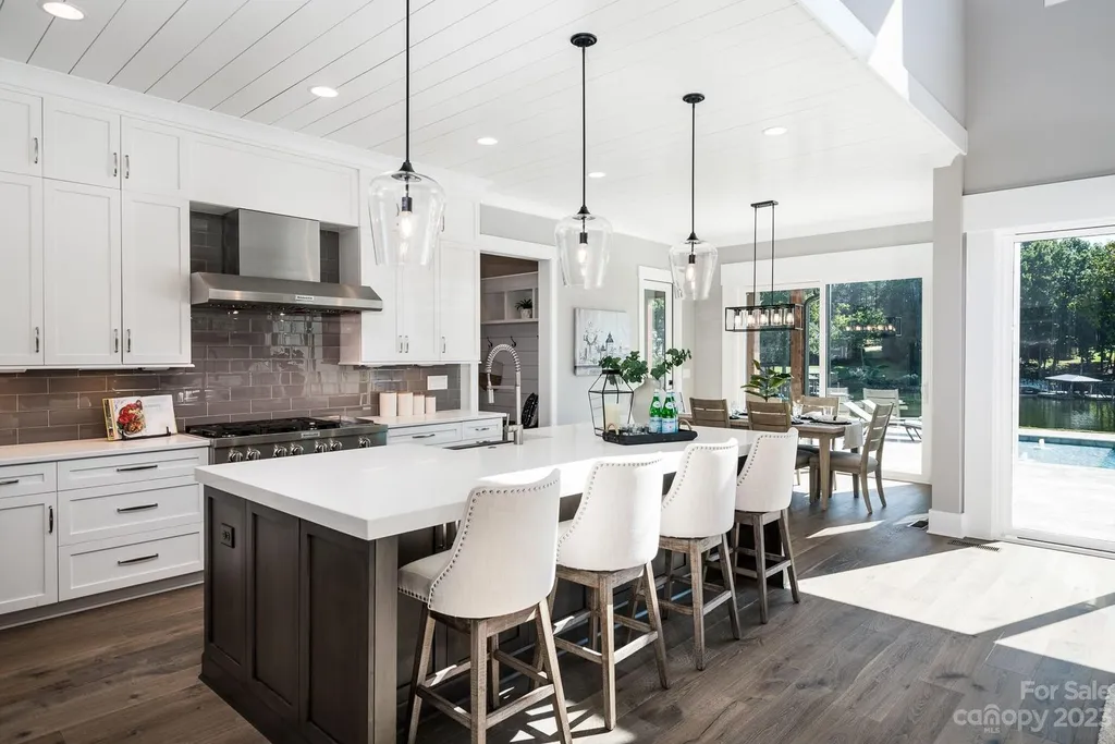 155 Riverwood Road Home in Mooresville, North Carolina. Experience the epitome of luxury in this new construction home on Lake Norman. Boasting 4 bedrooms, 4.5 bathrooms, a pool, dock, and breathtaking lake views, this home offers a lifestyle of comfort and elegance. 