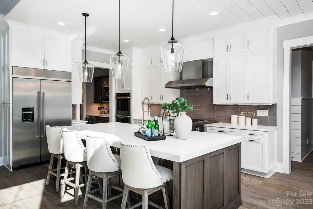 155 Riverwood Road Home in Mooresville, North Carolina. Experience the epitome of luxury in this new construction home on Lake Norman. Boasting 4 bedrooms, 4.5 bathrooms, a pool, dock, and breathtaking lake views, this home offers a lifestyle of comfort and elegance. 