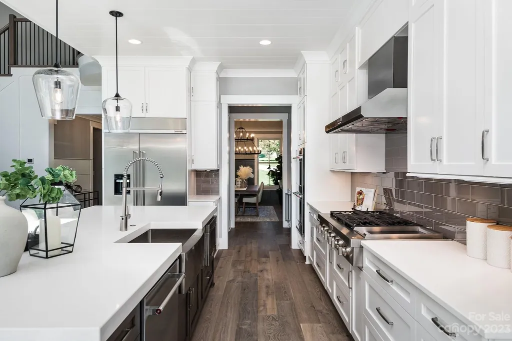 155 Riverwood Road Home in Mooresville, North Carolina. Experience the epitome of luxury in this new construction home on Lake Norman. Boasting 4 bedrooms, 4.5 bathrooms, a pool, dock, and breathtaking lake views, this home offers a lifestyle of comfort and elegance. 