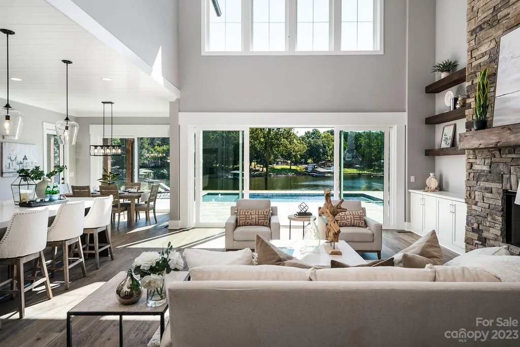 155 Riverwood Road Home in Mooresville, North Carolina. Experience the epitome of luxury in this new construction home on Lake Norman. Boasting 4 bedrooms, 4.5 bathrooms, a pool, dock, and breathtaking lake views, this home offers a lifestyle of comfort and elegance. 