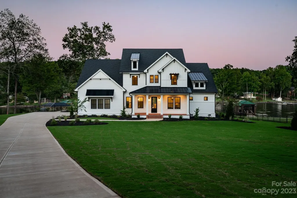 155 Riverwood Road Home in Mooresville, North Carolina. Experience the epitome of luxury in this new construction home on Lake Norman. Boasting 4 bedrooms, 4.5 bathrooms, a pool, dock, and breathtaking lake views, this home offers a lifestyle of comfort and elegance. 