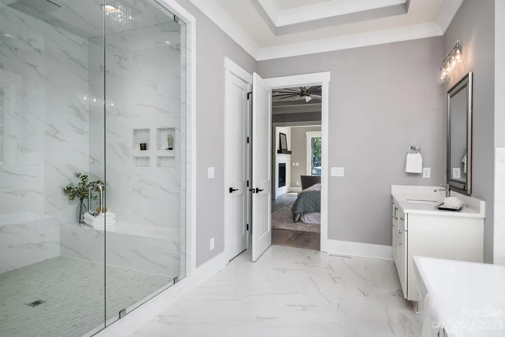 155 Riverwood Road Home in Mooresville, North Carolina. Experience the epitome of luxury in this new construction home on Lake Norman. Boasting 4 bedrooms, 4.5 bathrooms, a pool, dock, and breathtaking lake views, this home offers a lifestyle of comfort and elegance. 