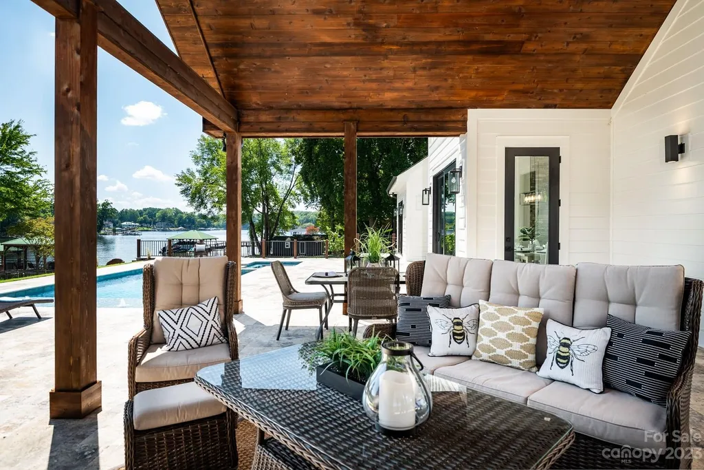 155 Riverwood Road Home in Mooresville, North Carolina. Experience the epitome of luxury in this new construction home on Lake Norman. Boasting 4 bedrooms, 4.5 bathrooms, a pool, dock, and breathtaking lake views, this home offers a lifestyle of comfort and elegance. 