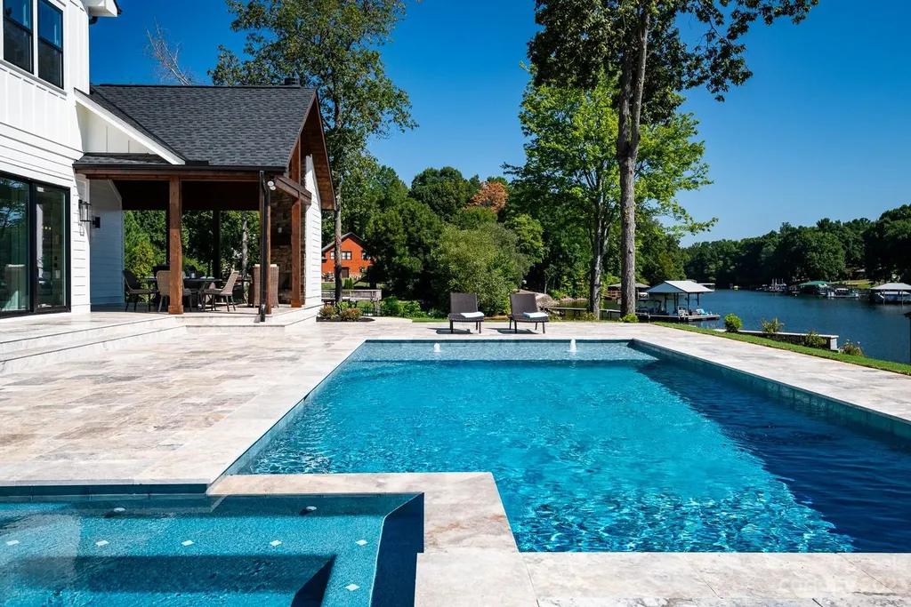 155 Riverwood Road Home in Mooresville, North Carolina. Experience the epitome of luxury in this new construction home on Lake Norman. Boasting 4 bedrooms, 4.5 bathrooms, a pool, dock, and breathtaking lake views, this home offers a lifestyle of comfort and elegance. 
