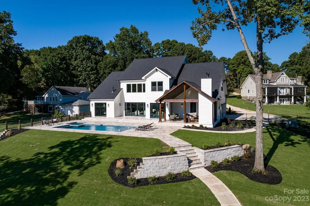 155 Riverwood Road Home in Mooresville, North Carolina. Experience the epitome of luxury in this new construction home on Lake Norman. Boasting 4 bedrooms, 4.5 bathrooms, a pool, dock, and breathtaking lake views, this home offers a lifestyle of comfort and elegance. 