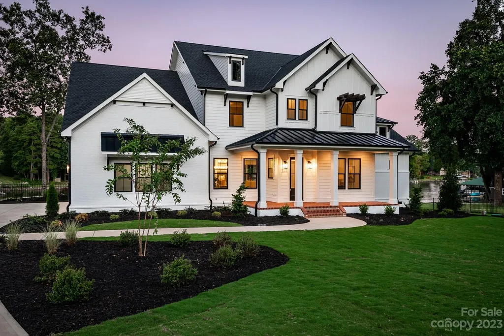 155 Riverwood Road Home in Mooresville, North Carolina. Experience the epitome of luxury in this new construction home on Lake Norman. Boasting 4 bedrooms, 4.5 bathrooms, a pool, dock, and breathtaking lake views, this home offers a lifestyle of comfort and elegance. 
