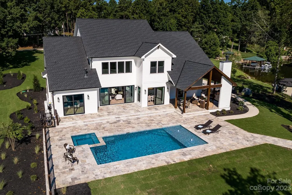 155 Riverwood Road Home in Mooresville, North Carolina. Experience the epitome of luxury in this new construction home on Lake Norman. Boasting 4 bedrooms, 4.5 bathrooms, a pool, dock, and breathtaking lake views, this home offers a lifestyle of comfort and elegance. 