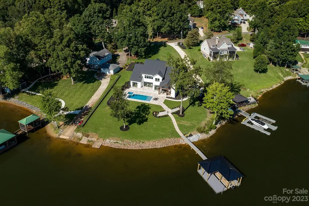 155 Riverwood Road Home in Mooresville, North Carolina. Experience the epitome of luxury in this new construction home on Lake Norman. Boasting 4 bedrooms, 4.5 bathrooms, a pool, dock, and breathtaking lake views, this home offers a lifestyle of comfort and elegance. 