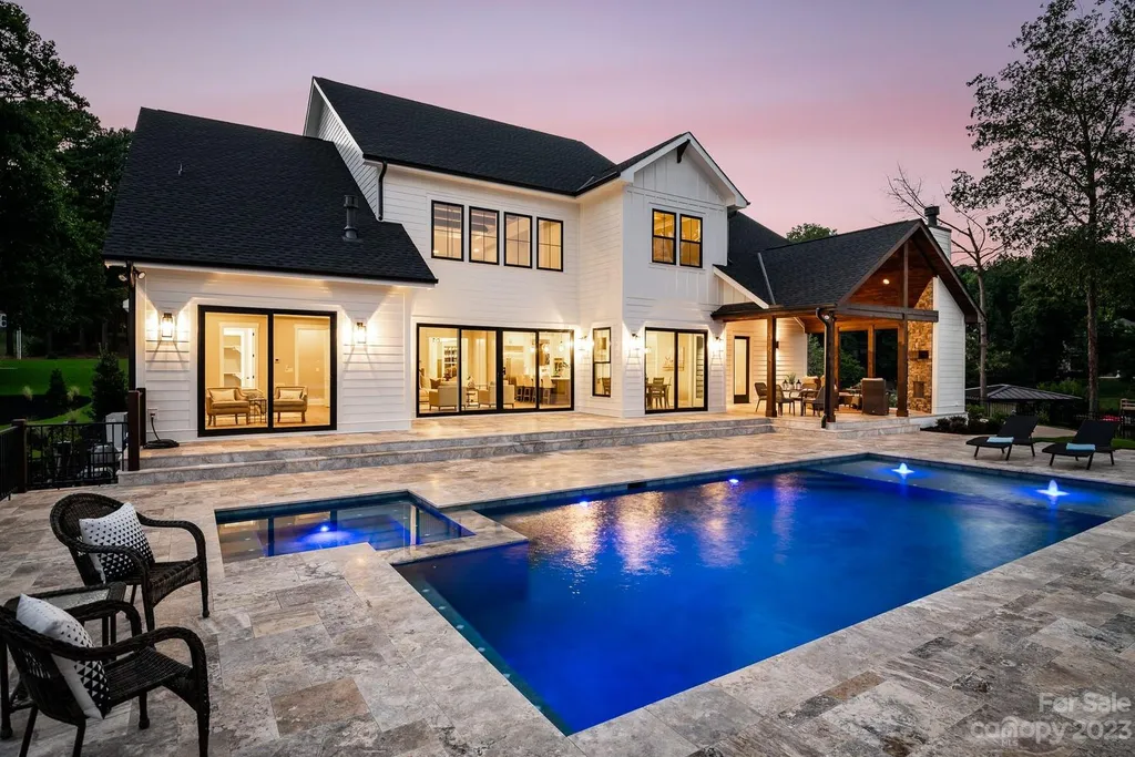 155 Riverwood Road Home in Mooresville, North Carolina. Experience the epitome of luxury in this new construction home on Lake Norman. Boasting 4 bedrooms, 4.5 bathrooms, a pool, dock, and breathtaking lake views, this home offers a lifestyle of comfort and elegance. 