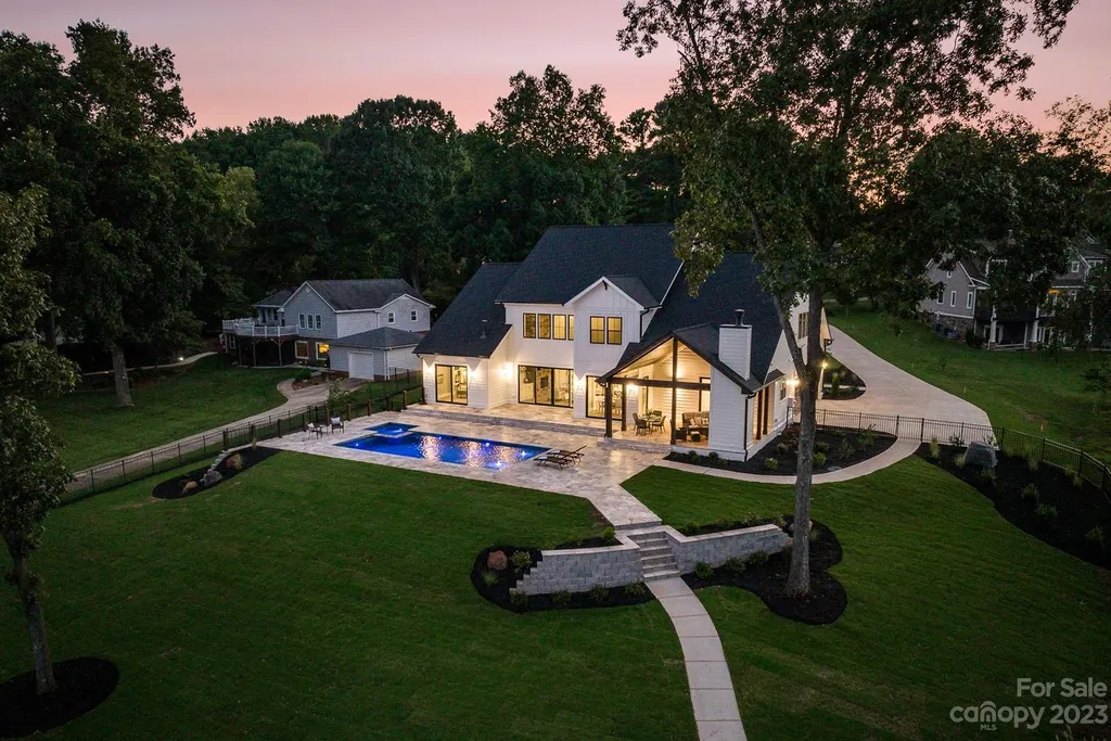 155 Riverwood Road Home in Mooresville, North Carolina. Experience the epitome of luxury in this new construction home on Lake Norman. Boasting 4 bedrooms, 4.5 bathrooms, a pool, dock, and breathtaking lake views, this home offers a lifestyle of comfort and elegance. 