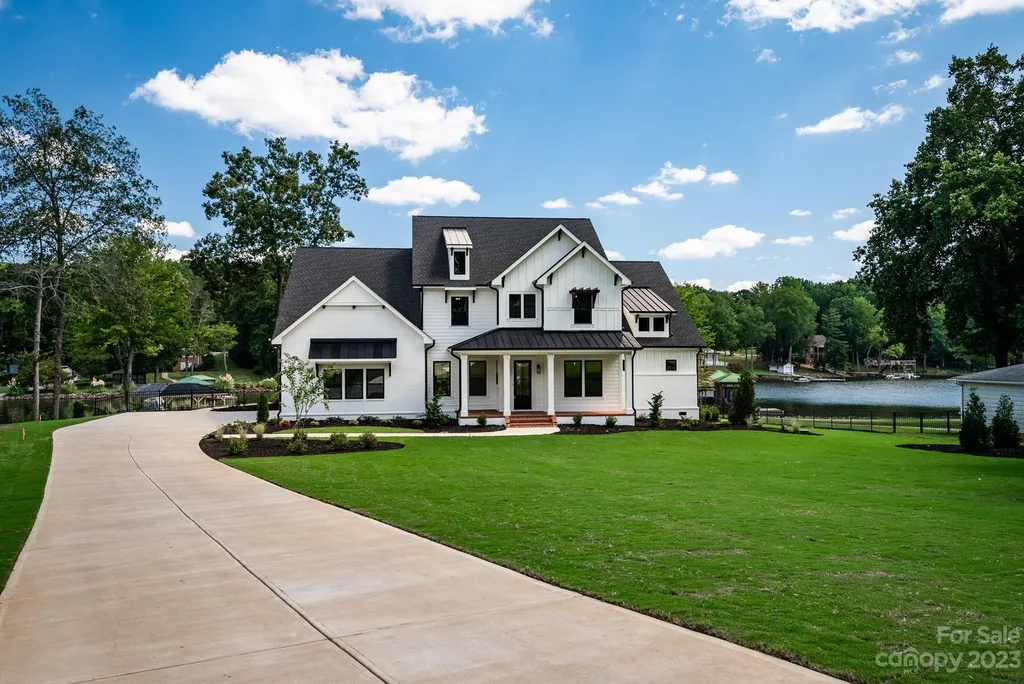 155 Riverwood Road Home in Mooresville, North Carolina. Experience the epitome of luxury in this new construction home on Lake Norman. Boasting 4 bedrooms, 4.5 bathrooms, a pool, dock, and breathtaking lake views, this home offers a lifestyle of comfort and elegance. 