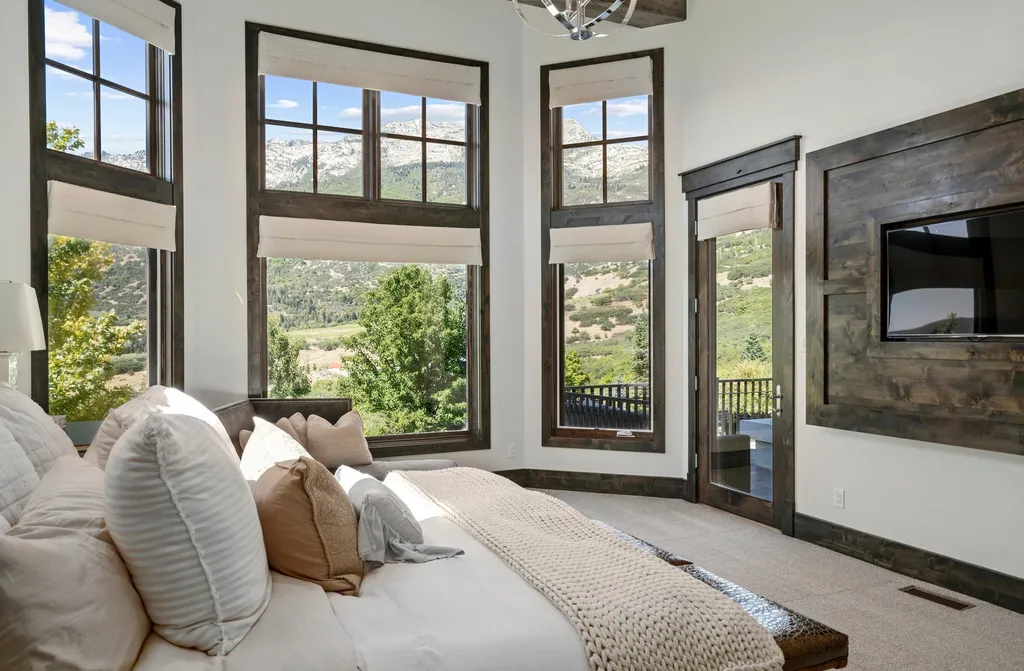 1643 E Box Elder Drive Home in Alpine, Utah. Few homes capture the majesty and beauty of Alpine's surrounding mountains like this one. This former parade of homes prize winner boasts panoramic views from every room. Impeccable attention to detail is evident throughout, with beautiful wood trim accentuating the warmth of the gathering areas. 
