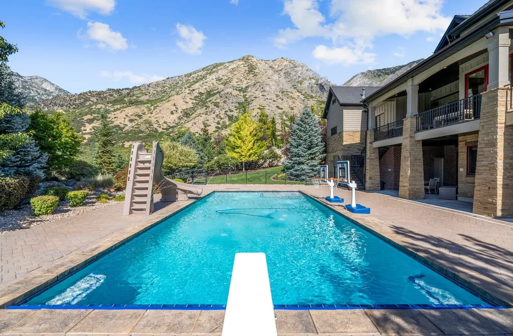 1643 E Box Elder Drive Home in Alpine, Utah. Few homes capture the majesty and beauty of Alpine's surrounding mountains like this one. This former parade of homes prize winner boasts panoramic views from every room. Impeccable attention to detail is evident throughout, with beautiful wood trim accentuating the warmth of the gathering areas. 