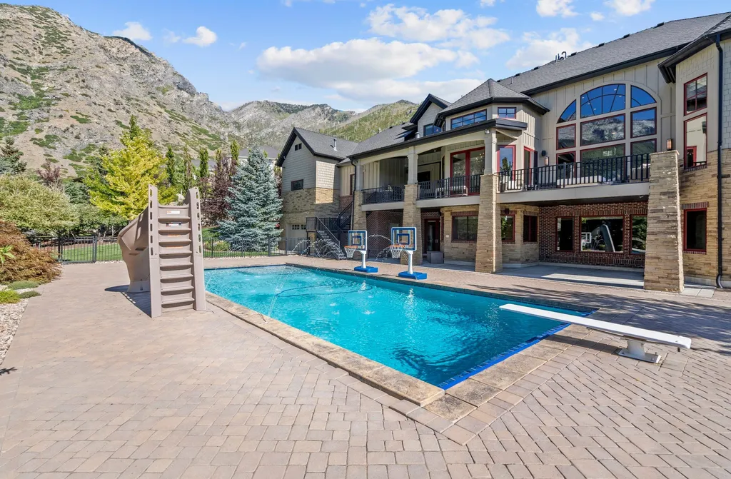 1643 E Box Elder Drive Home in Alpine, Utah. Few homes capture the majesty and beauty of Alpine's surrounding mountains like this one. This former parade of homes prize winner boasts panoramic views from every room. Impeccable attention to detail is evident throughout, with beautiful wood trim accentuating the warmth of the gathering areas. 