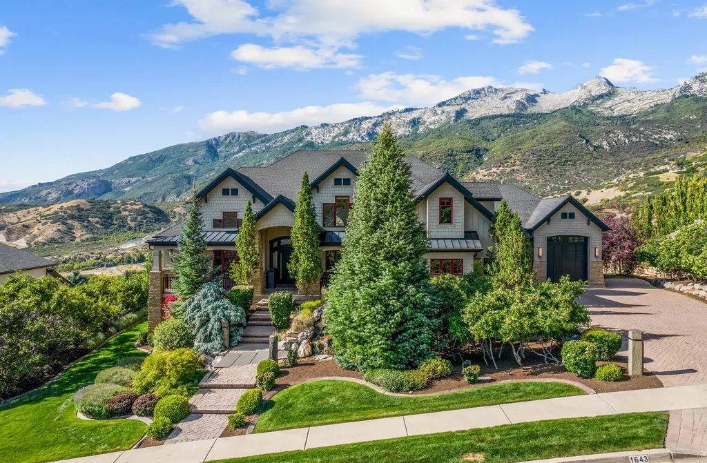 1643 E Box Elder Drive Home in Alpine, Utah. Few homes capture the majesty and beauty of Alpine's surrounding mountains like this one. This former parade of homes prize winner boasts panoramic views from every room. Impeccable attention to detail is evident throughout, with beautiful wood trim accentuating the warmth of the gathering areas. 