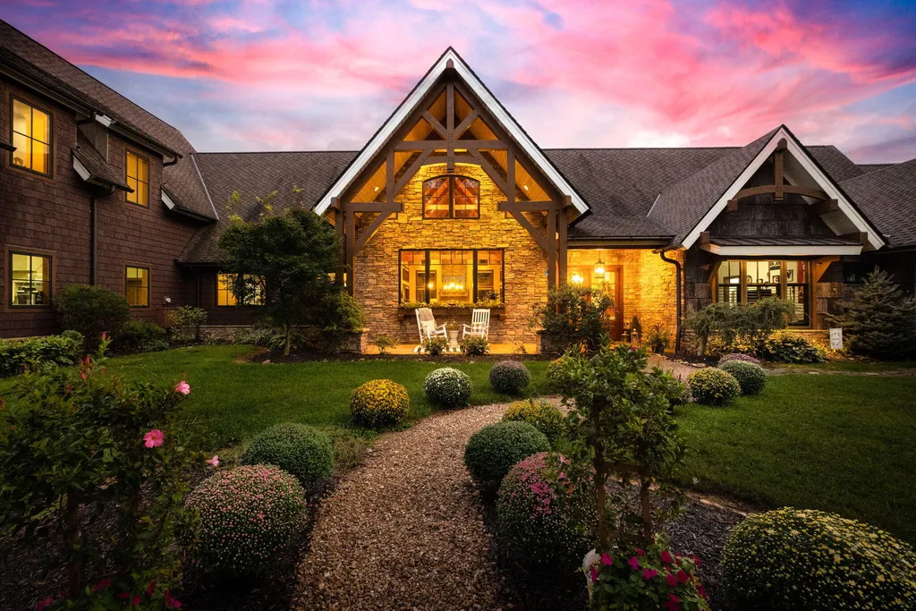 180 Riverwalk Court Home in Greeneville, Tennessee. Discover your dream oasis on this breathtaking 5-acre riverfront property! This extraordinary 7,000+ sqft home seamlessly blends transitional architecture with rustic charm, creating a captivating retreat. The striking blend of stone and poplar wood siding on the exterior exudes warmth and charm.