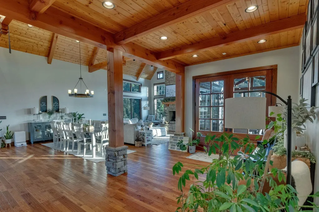 180 Riverwalk Court Home in Greeneville, Tennessee. Discover your dream oasis on this breathtaking 5-acre riverfront property! This extraordinary 7,000+ sqft home seamlessly blends transitional architecture with rustic charm, creating a captivating retreat. The striking blend of stone and poplar wood siding on the exterior exudes warmth and charm.