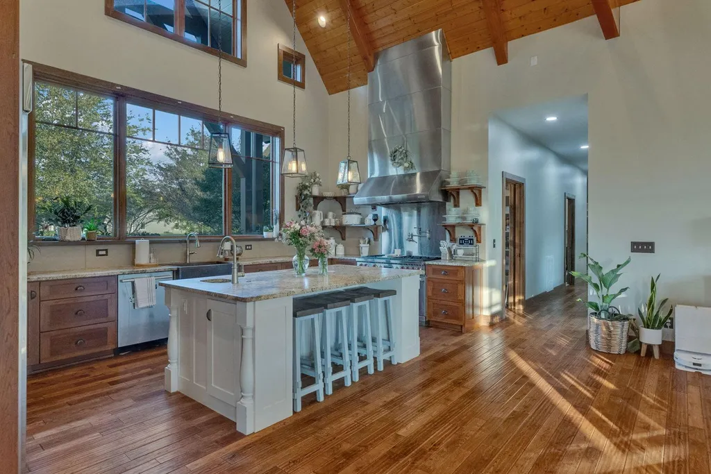 180 Riverwalk Court Home in Greeneville, Tennessee. Discover your dream oasis on this breathtaking 5-acre riverfront property! This extraordinary 7,000+ sqft home seamlessly blends transitional architecture with rustic charm, creating a captivating retreat. The striking blend of stone and poplar wood siding on the exterior exudes warmth and charm.