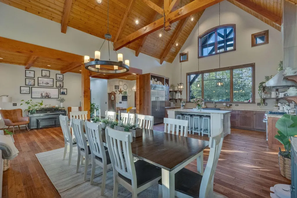180 Riverwalk Court Home in Greeneville, Tennessee. Discover your dream oasis on this breathtaking 5-acre riverfront property! This extraordinary 7,000+ sqft home seamlessly blends transitional architecture with rustic charm, creating a captivating retreat. The striking blend of stone and poplar wood siding on the exterior exudes warmth and charm.