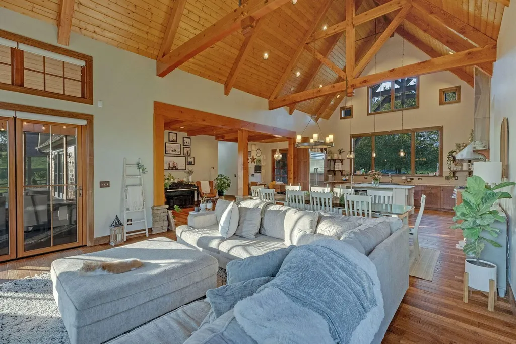 180 Riverwalk Court Home in Greeneville, Tennessee. Discover your dream oasis on this breathtaking 5-acre riverfront property! This extraordinary 7,000+ sqft home seamlessly blends transitional architecture with rustic charm, creating a captivating retreat. The striking blend of stone and poplar wood siding on the exterior exudes warmth and charm.