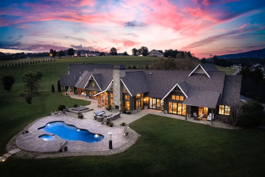 180 Riverwalk Court Home in Greeneville, Tennessee. Discover your dream oasis on this breathtaking 5-acre riverfront property! This extraordinary 7,000+ sqft home seamlessly blends transitional architecture with rustic charm, creating a captivating retreat. The striking blend of stone and poplar wood siding on the exterior exudes warmth and charm.