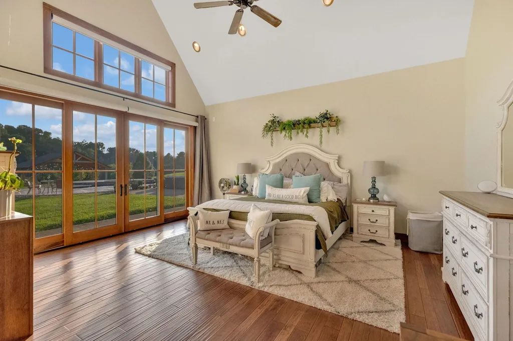 180 Riverwalk Court Home in Greeneville, Tennessee. Discover your dream oasis on this breathtaking 5-acre riverfront property! This extraordinary 7,000+ sqft home seamlessly blends transitional architecture with rustic charm, creating a captivating retreat. The striking blend of stone and poplar wood siding on the exterior exudes warmth and charm.