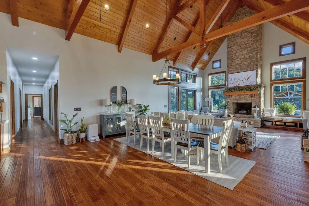 180 Riverwalk Court Home in Greeneville, Tennessee. Discover your dream oasis on this breathtaking 5-acre riverfront property! This extraordinary 7,000+ sqft home seamlessly blends transitional architecture with rustic charm, creating a captivating retreat. The striking blend of stone and poplar wood siding on the exterior exudes warmth and charm.