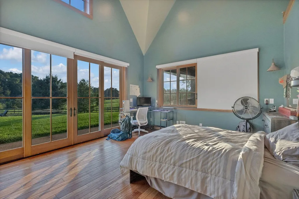 180 Riverwalk Court Home in Greeneville, Tennessee. Discover your dream oasis on this breathtaking 5-acre riverfront property! This extraordinary 7,000+ sqft home seamlessly blends transitional architecture with rustic charm, creating a captivating retreat. The striking blend of stone and poplar wood siding on the exterior exudes warmth and charm.