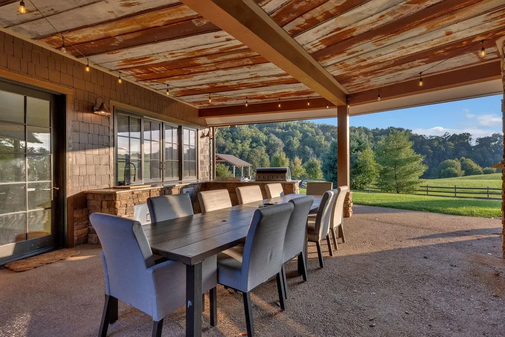 180 Riverwalk Court Home in Greeneville, Tennessee. Discover your dream oasis on this breathtaking 5-acre riverfront property! This extraordinary 7,000+ sqft home seamlessly blends transitional architecture with rustic charm, creating a captivating retreat. The striking blend of stone and poplar wood siding on the exterior exudes warmth and charm.