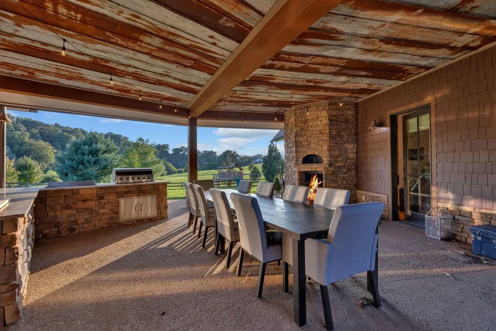 180 Riverwalk Court Home in Greeneville, Tennessee. Discover your dream oasis on this breathtaking 5-acre riverfront property! This extraordinary 7,000+ sqft home seamlessly blends transitional architecture with rustic charm, creating a captivating retreat. The striking blend of stone and poplar wood siding on the exterior exudes warmth and charm.