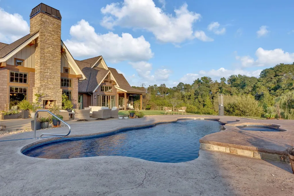 180 Riverwalk Court Home in Greeneville, Tennessee. Discover your dream oasis on this breathtaking 5-acre riverfront property! This extraordinary 7,000+ sqft home seamlessly blends transitional architecture with rustic charm, creating a captivating retreat. The striking blend of stone and poplar wood siding on the exterior exudes warmth and charm.