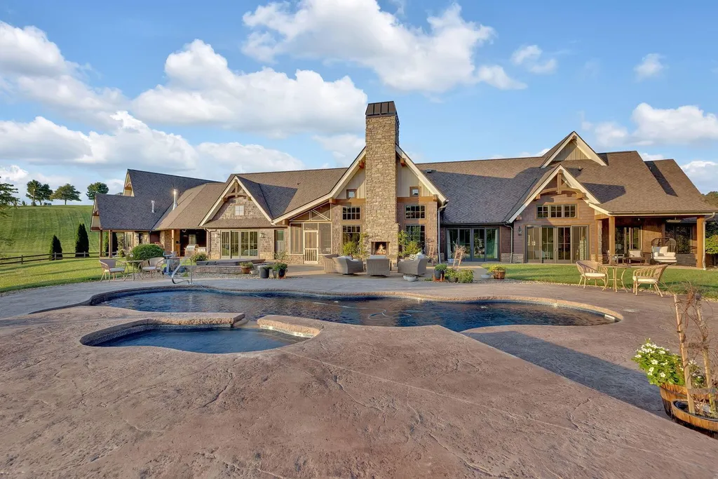 180 Riverwalk Court Home in Greeneville, Tennessee. Discover your dream oasis on this breathtaking 5-acre riverfront property! This extraordinary 7,000+ sqft home seamlessly blends transitional architecture with rustic charm, creating a captivating retreat. The striking blend of stone and poplar wood siding on the exterior exudes warmth and charm.