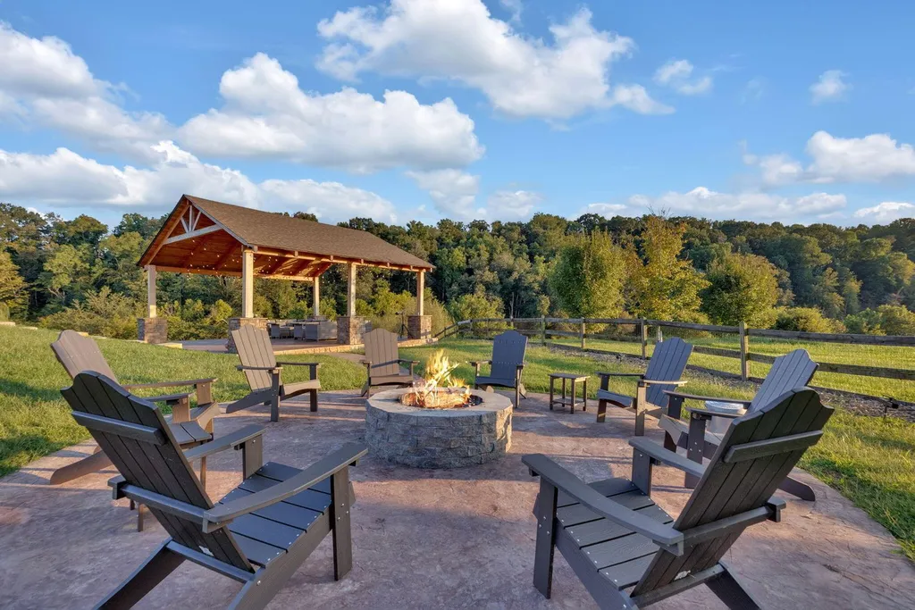180 Riverwalk Court Home in Greeneville, Tennessee. Discover your dream oasis on this breathtaking 5-acre riverfront property! This extraordinary 7,000+ sqft home seamlessly blends transitional architecture with rustic charm, creating a captivating retreat. The striking blend of stone and poplar wood siding on the exterior exudes warmth and charm.