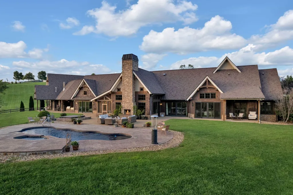 180 Riverwalk Court Home in Greeneville, Tennessee. Discover your dream oasis on this breathtaking 5-acre riverfront property! This extraordinary 7,000+ sqft home seamlessly blends transitional architecture with rustic charm, creating a captivating retreat. The striking blend of stone and poplar wood siding on the exterior exudes warmth and charm.