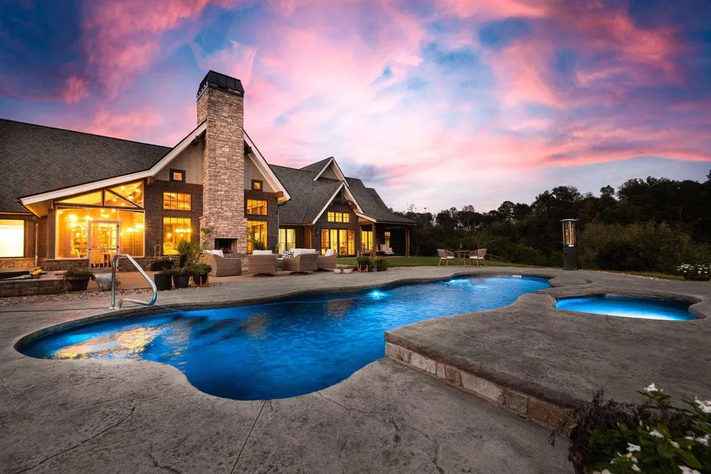 180 Riverwalk Court Home in Greeneville, Tennessee. Discover your dream oasis on this breathtaking 5-acre riverfront property! This extraordinary 7,000+ sqft home seamlessly blends transitional architecture with rustic charm, creating a captivating retreat. The striking blend of stone and poplar wood siding on the exterior exudes warmth and charm.