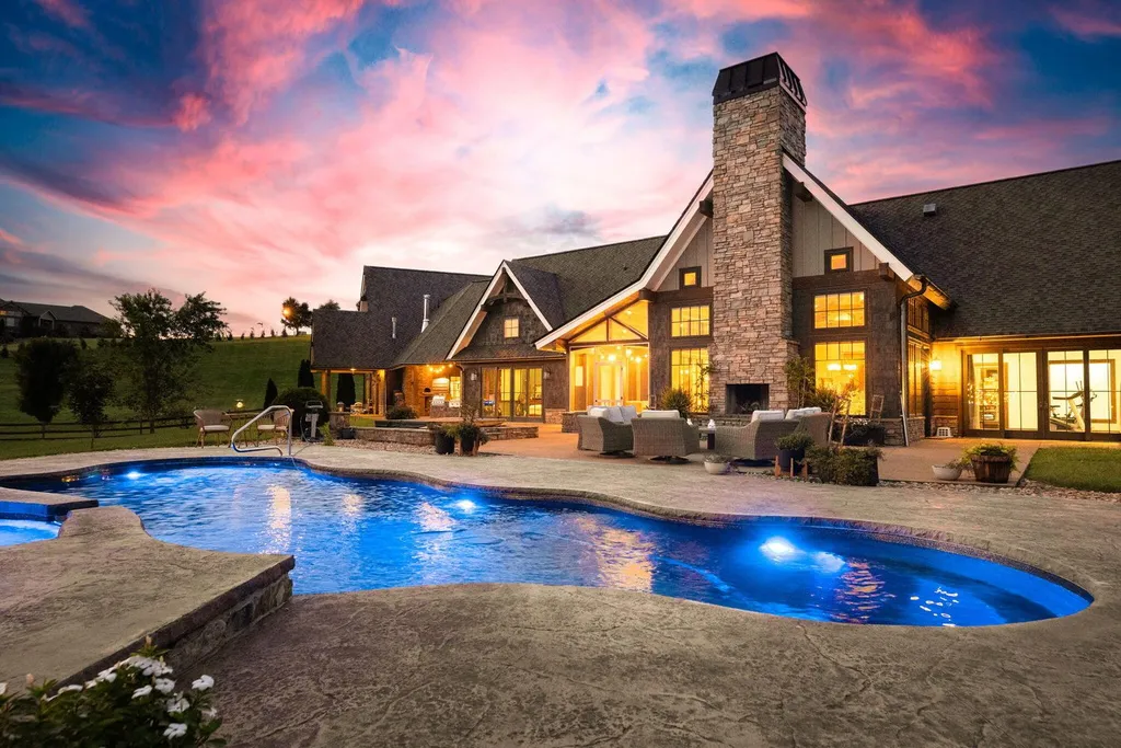 180 Riverwalk Court Home in Greeneville, Tennessee. Discover your dream oasis on this breathtaking 5-acre riverfront property! This extraordinary 7,000+ sqft home seamlessly blends transitional architecture with rustic charm, creating a captivating retreat. The striking blend of stone and poplar wood siding on the exterior exudes warmth and charm.
